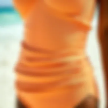 Close-up of fabric and detailing of a ruched bottom one piece swimsuit