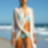 Elegant beach cover-up draping over a two-piece bathing suit