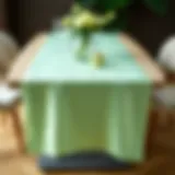 Elegant mint green satin table runner on a stylish dining table