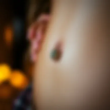 Cultural Significance of Tiny Belly Button Rings Cultural symbols represented through unique tiny belly button ring designs.