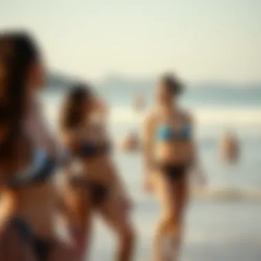 An aesthetically pleasing beach scene with individuals enjoying the sun in two-piece swimsuits.